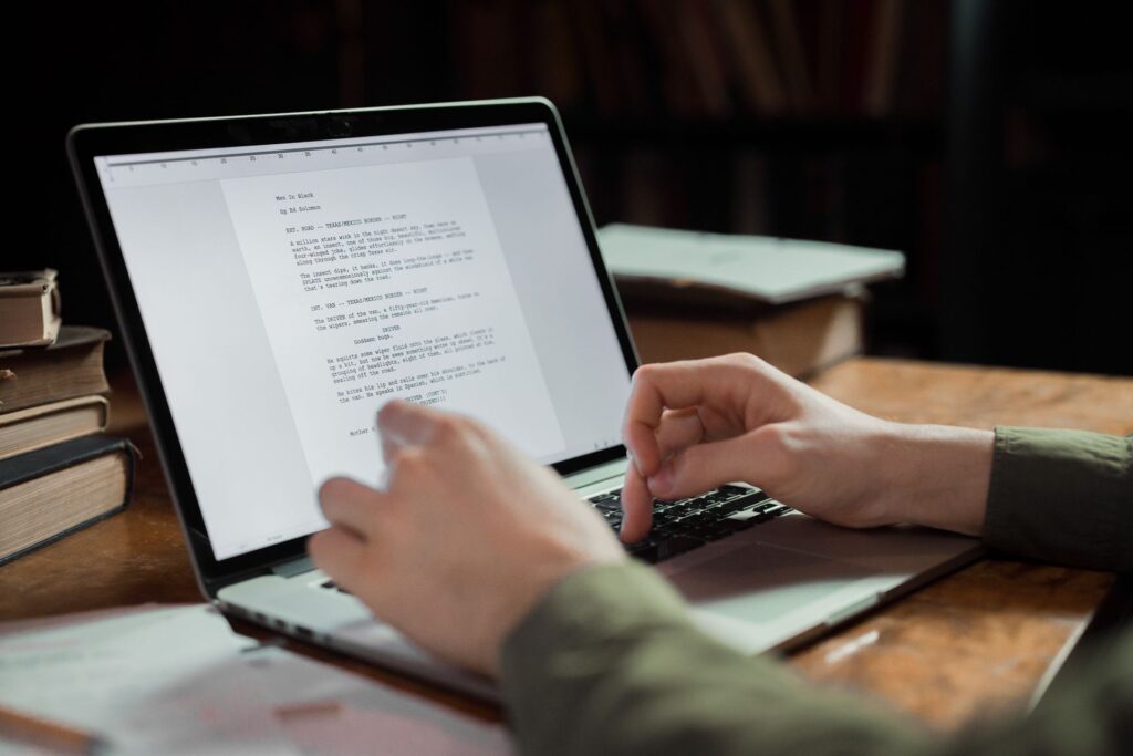 Content writer editing an AI-assisted draft on a laptop
